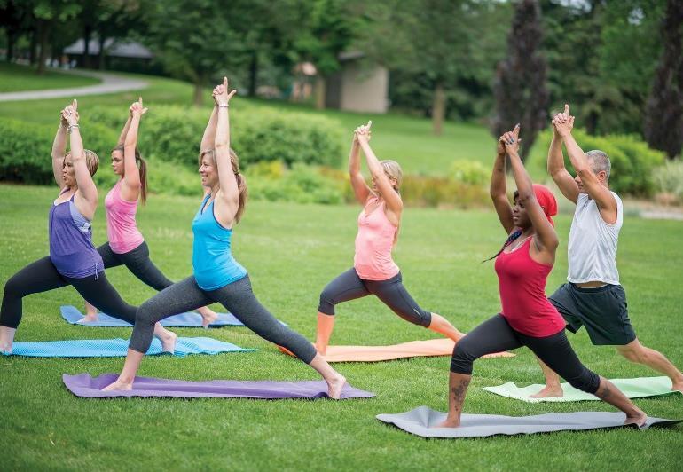 Men and women participate in Yoga.